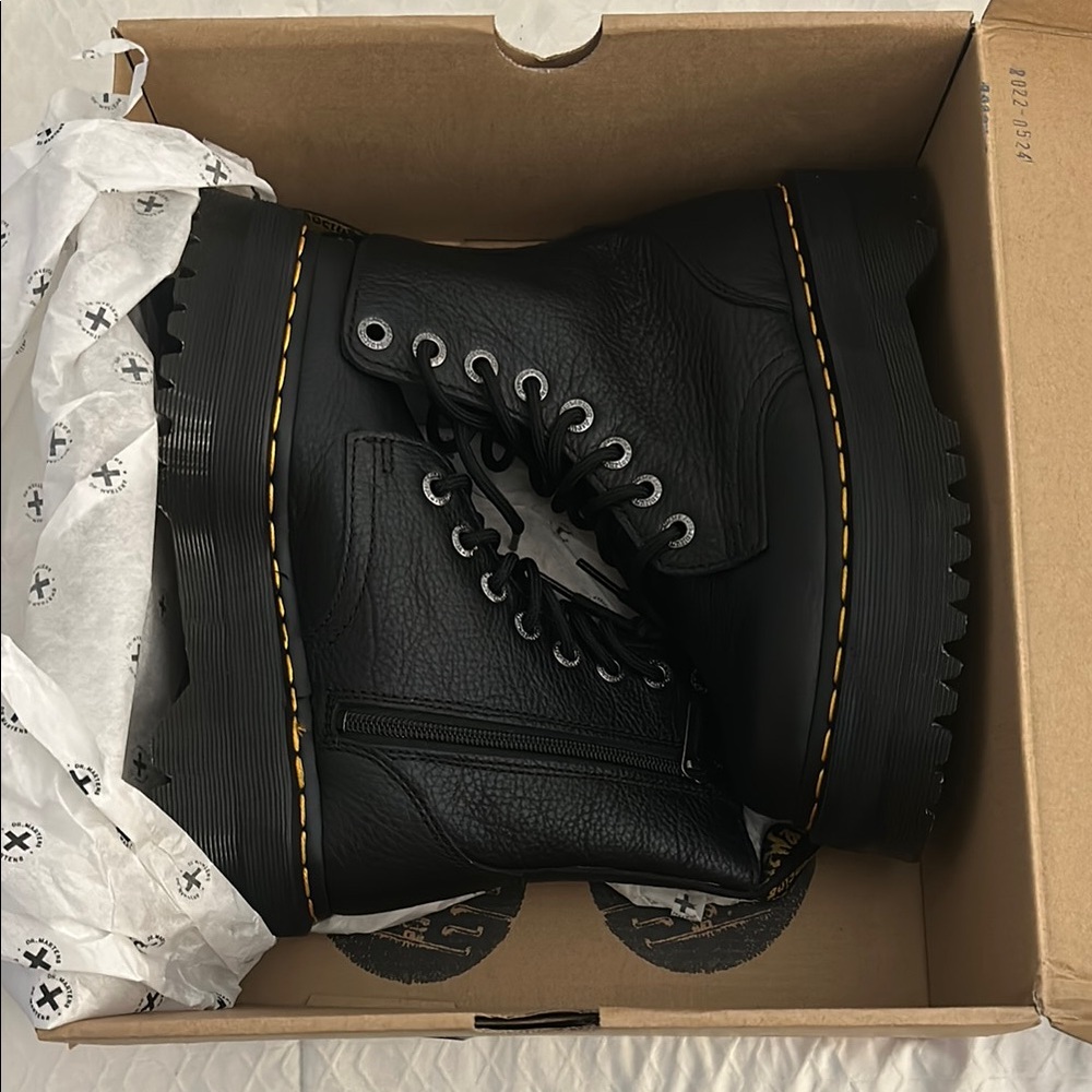 Dr. Martens Black Combat Boots with Rugged Design and Durable Leather